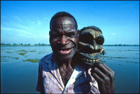 Marcus Mongwa, Sepik River artist, holding a sculpture he made containing human hair. Kaminabit Village, Middle Sepik, Papua New Guinea 1983